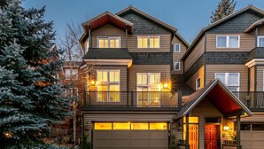 A multi-story residential building with a garage, balconies, and a red door. - Labor Day Sale - Limited Time Offer, Save up to 30% (Park City)