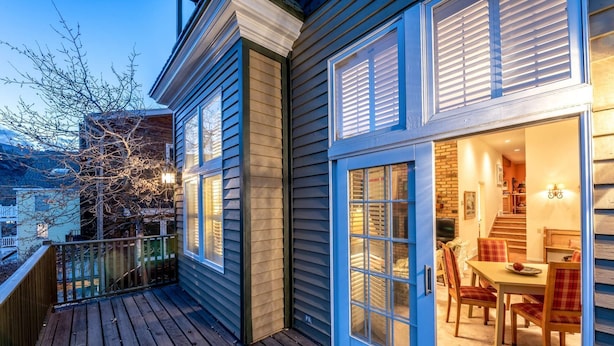 A two-story house with a wooden deck and a dining area visible through the open front door. - Labor Day Sale - Limited Time Offer, Save up to 30% (Park City)
