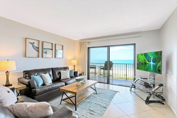 Bright and airy living room opens to a private balcony with ocean views.