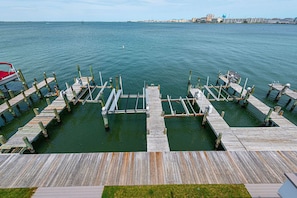 A pier with wooden walkways and a boat docked on the left.