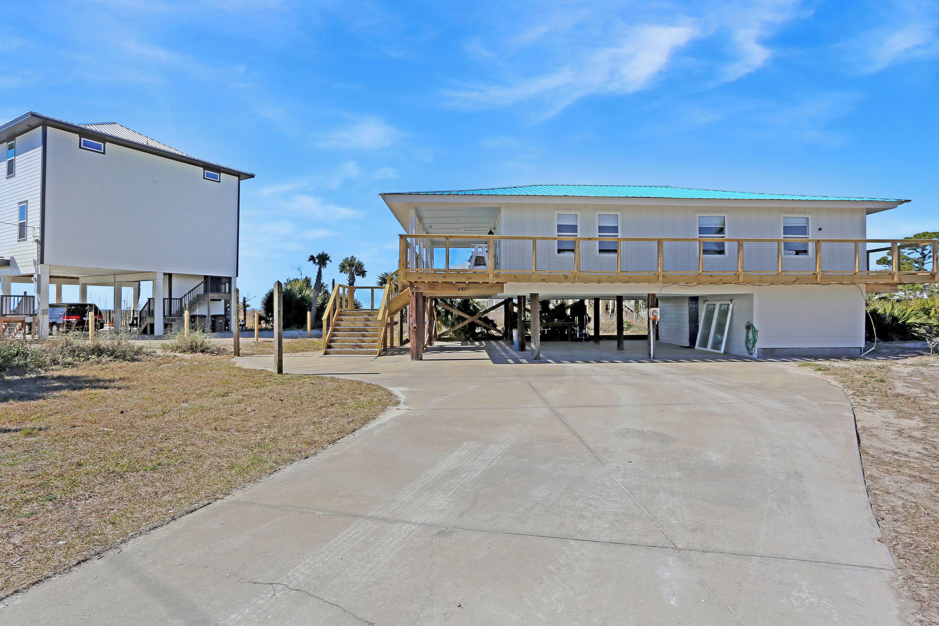 A two-story building with a covered walkway and a staircase leading to the upper floor.