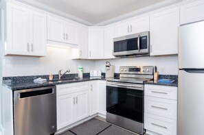 Enjoy cooking in this fully equipped kitchen with a dishwasher, microwave, oven, and refrigerator.