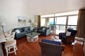 Living area - Stylish, spacious 2 bedroom oceanfront condo with owner provided WiFi, 3 flat screen televisions (all with HBO and Disney channels and blue ray players) , floral decor, and a deluxe balcony with a spectacular ocean view located uptown just steps to (Ocean City)
