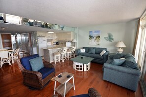 Living area - Stylish, spacious 2 bedroom oceanfront condo with owner provided WiFi, 3 flat screen televisions (all with HBO and Disney channels and blue ray players) , floral decor, and a deluxe balcony with a spectacular ocean view located uptown just steps to (Ocean City)
