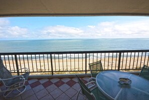 Outdoor dining - Stylish, spacious 2 bedroom oceanfront condo with owner provided  WiFi, 3 flat screen televisions (all with HBO and Disney channels and blue ray players) , floral decor, and a deluxe balcony with a spectacular ocean view located uptown just steps to (Ocean City)