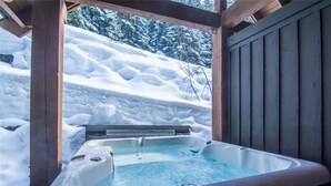 A hot tub in a wooden structure with snow-covered surroundings. - Ski-In/Ski-Out | Mountain Views | Private Hot Tub | Modern 3BR | Managed by Aloha Whistler (Whistler)