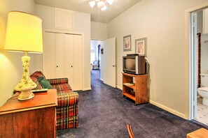 Cozy living space with a sofa, side table, and TV.