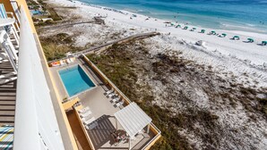 A hotel with a pool, beach view, and beach umbrellas. - GD 608: Seas the Gulf - Waves at Your Doorstep! (Fort Walton Beach)