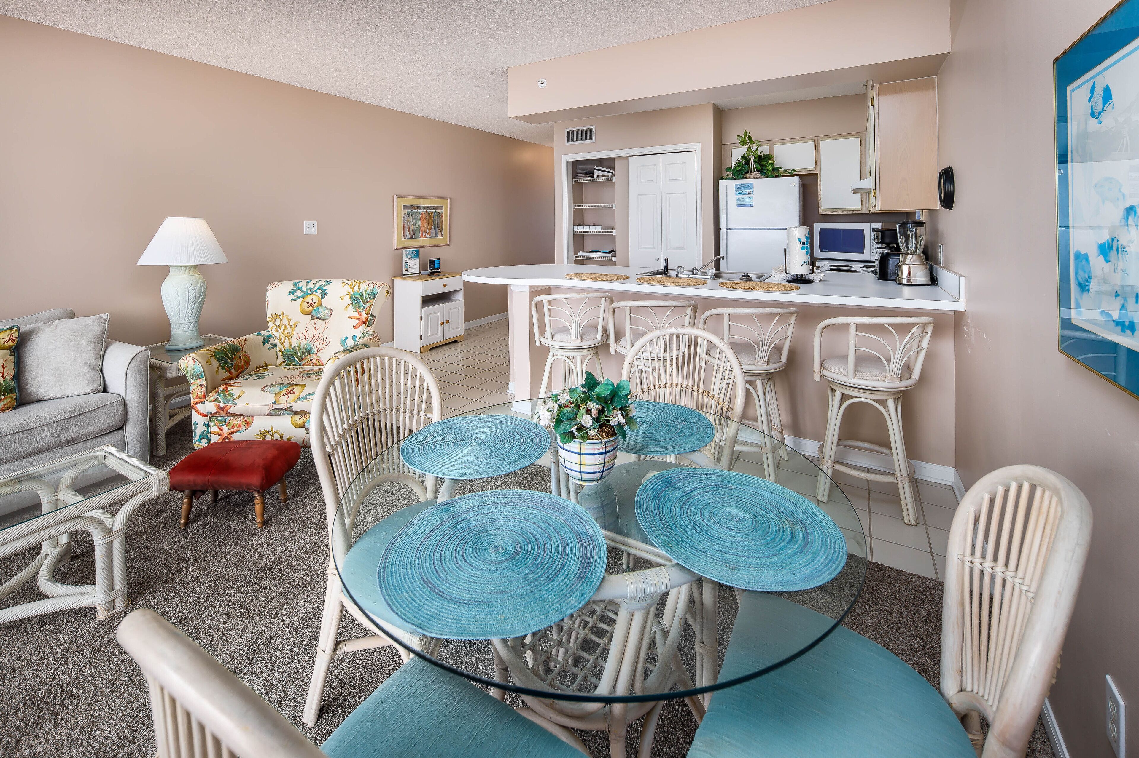 A compact living space with a dining area, kitchenette, and a sofa.