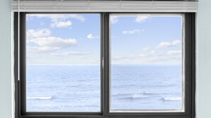 A window with a view of the ocean and sky. - *Fall into Savings-20% Off New Bookings thru 2026* (Garden City)