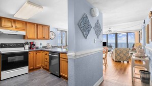 A kitchen with wooden cabinets, a stove, and a dishwasher. - *Fall into Savings-20% Off New Bookings thru 2026* (Garden City)