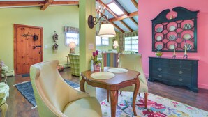 A dining area with a wooden table, chairs, and a chandelier. - 'La Petite Chalet' w/ Blue Ridge Mountain Views! (Little Switzerland)