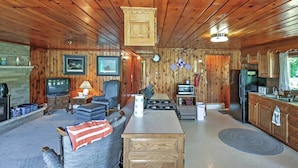 A cozy cabin interior with a living room, kitchen, and dining area. - 2 Mi to Boat Ramp! Family Cabin on Long Lake (Hale)