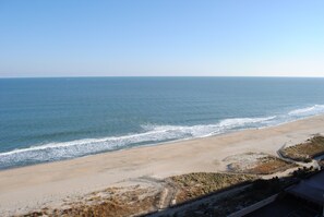 A beach with a sandy shore and a clear view of the ocean.