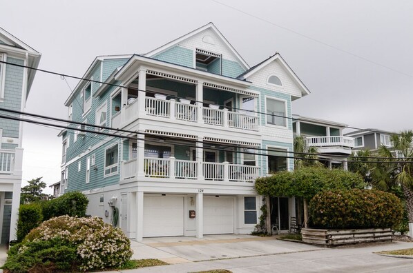 A two-story residential building with a balcony on the second floor.