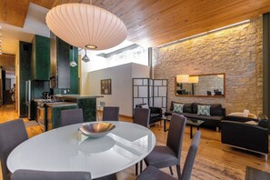 A modern interior with a dining area, kitchen, and living space.