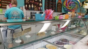 A dessert display with various ice cream flavors and waffle cones. - Ride the Tide – Heated Pool Home | Steps to Holmes Beach | Heated Pool | Free WIFI & Trolley , NO Roads to Cross, Dog*(See Note)Allow (Holmes Beach)