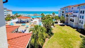 Ein Resort mit Pool, Palmen und Meerblick.
