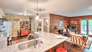 A kitchen with granite countertops, a stainless steel sink, and wooden cabinets. - Relaxing Eagle Rock Resort Home - 1 Block to Lake! (Hazleton)