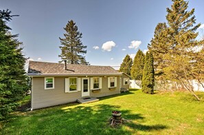A single-story house with a sloped roof, a front porch, and a small front yard.