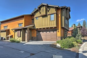 The home's rustic feel is highlighted by the wood and stone-accented exterior.