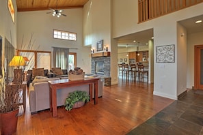 Cozy living area with a fireplace, sofa, and dining area.