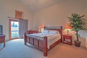 Relax in a spacious bedroom with a large bed, bedside table, and a balcony view.