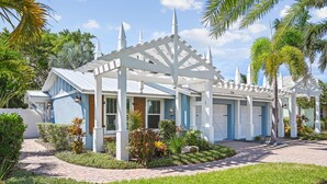 A two-story house with a white porch and a garage.