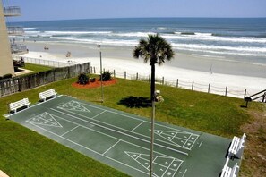 A shuffleboard court adjacent to a beach with ocean views. - Cute 2/2!Direct Oceanfront Complex on the No Drive Beach in NSB! (New Smyrna Beach)