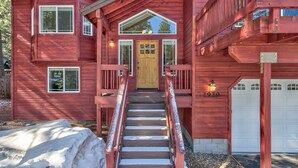 A two-story wooden house with a front porch, a staircase, and a garage. - Blackfoot Family Estate (South Lake Tahoe)