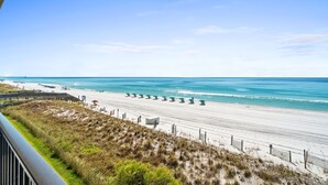 A beach with a clear sky, sandy shore, and a wooden walkway leading to the water. - ETW 3006: Beach Paradise - Rise and shine on beach time! Book now! (Fort Walton Beach)