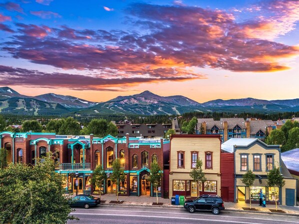 A row of colorful buildings with a mountain backdrop.