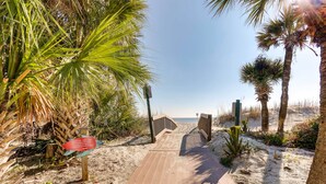 A wooden boardwalk leading to a beach with palm trees and a clear sky. - Walk to Beach: Hilton Head Resort Condo w/ Pools! (Hilton Head Island)