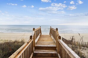 A wooden boardwalk leading to a beach with the ocean in the background. - WH1019- Oceanfront Oasis! Featuring 3 BRs, Wifi, Ocean Views and Hot Tub!! (Corolla)