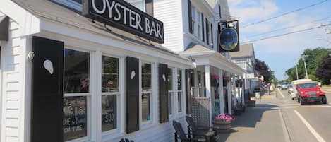 A white building with a sign reading "OYSTER BAR" and a smaller sign for "THE PORT".