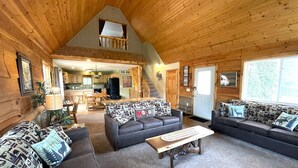 A log cabin interior with a living room, kitchen, and dining area. - Loose Moose @ Spring Brook Resort (Wisconsin Dells)
