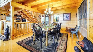 A wooden interior with a dining area, staircase, and a bear statue. - Hot Tub + Games! Mtn-View Cabin Near Pigeon Forge (Sevierville)