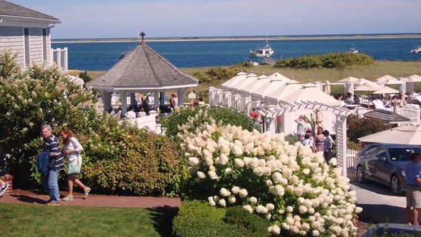 A coastal area with a gazebo, white tents, and a garden with white flowers. - The Heron's Nest - Sea Breezes & Sweet Dreams (Chatham)
