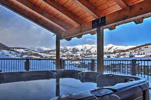 A hot tub under a wooden pergola with a view of snow-covered mountains and a lake. - 'Eagle's Nest' Crested Butte Townhome w/ Mtn Views (Crested Butte)