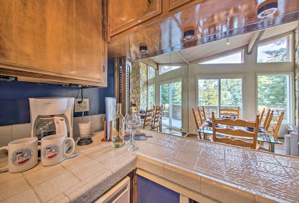Enjoy a kitchen with a large window offering a view of the outdoors, featuring a coffee maker and ample counter space.