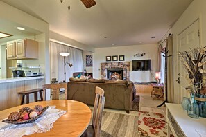 Relax in a cozy living room with a fireplace, comfortable seating, and a dining area.