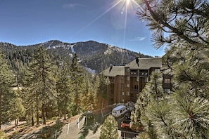 Surrounded by evergreen trees, this mountain lodge offers a serene retreat with stunning views of the snow-capped peak.