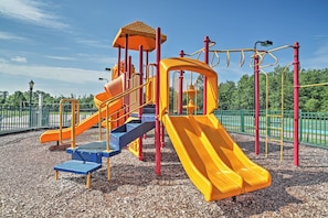 Kids can play on the playground's slides and climbing elements.