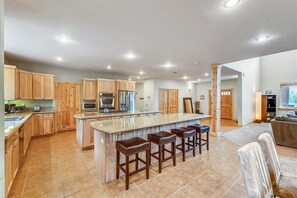 Enjoy cooking in this well-equipped kitchen with a central island and bar stools.