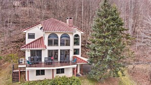 A two-story house with a balcony and a large tree in front. - Secluded Home w/ Views in Burnsville: Hike & Ski! (Burnsville)