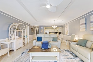 A modern living room with a sofa, coffee table, and decorative items.