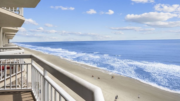 A beach view from a balcony with a clear sky and ocean waves. - *Fall into Savings-20% Off New Bookings thru 2026* (Murrells Inlet)
