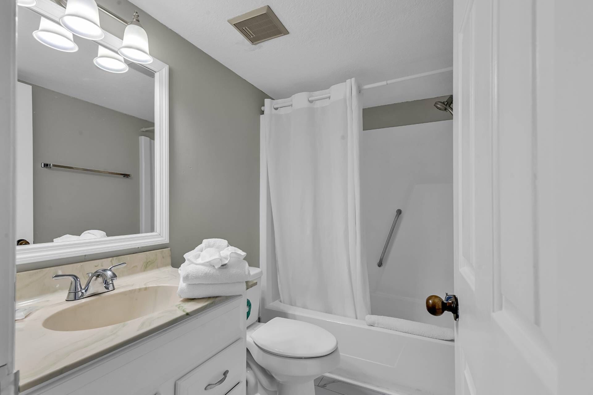 A bathroom with a sink, toilet, and shower.