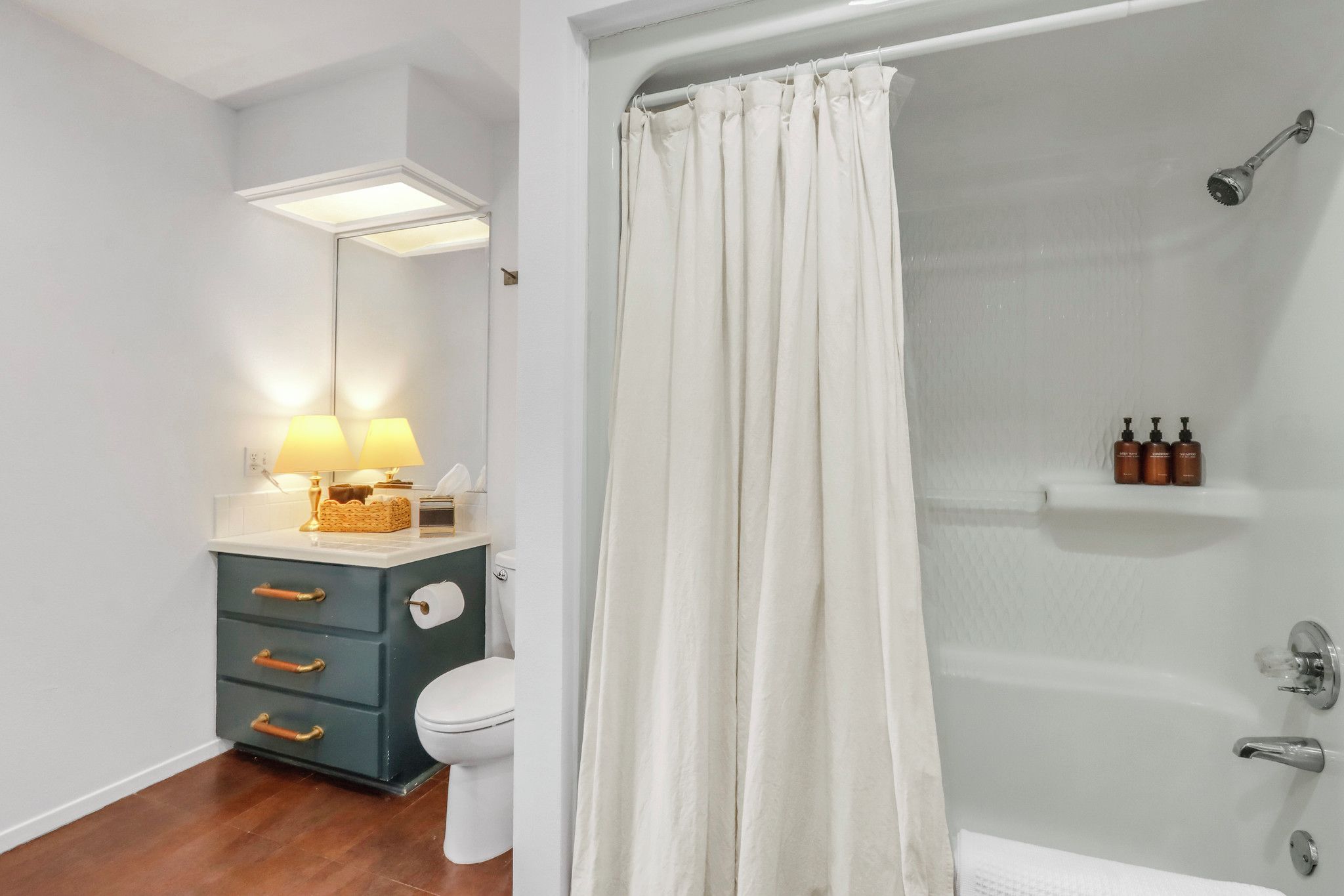 The bathroom has a shower/tub combo - Guest House