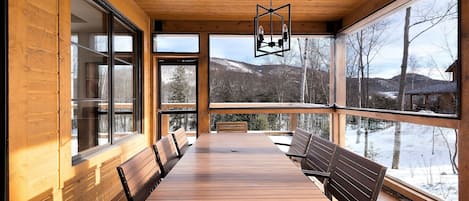 Enjoy meals on the deck with a view of the surrounding mountains.